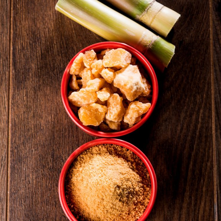 Organic Gur or Jaggery Powder is unrefined sugar obtained from concentrated sugarcane juice. served in a bowl. selective focus
