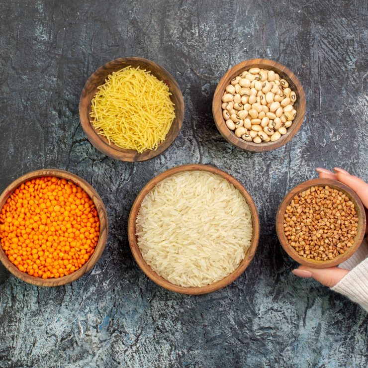 top-view-raw-rice-with-vermicelli-raw-buckwheat-inside-little-pots-light-grey-table